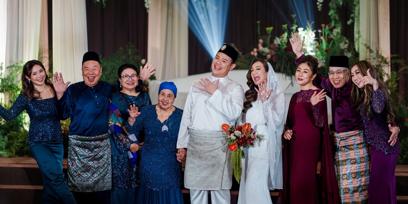 Multi-Generational Family Celebration Waving and Showing Rings